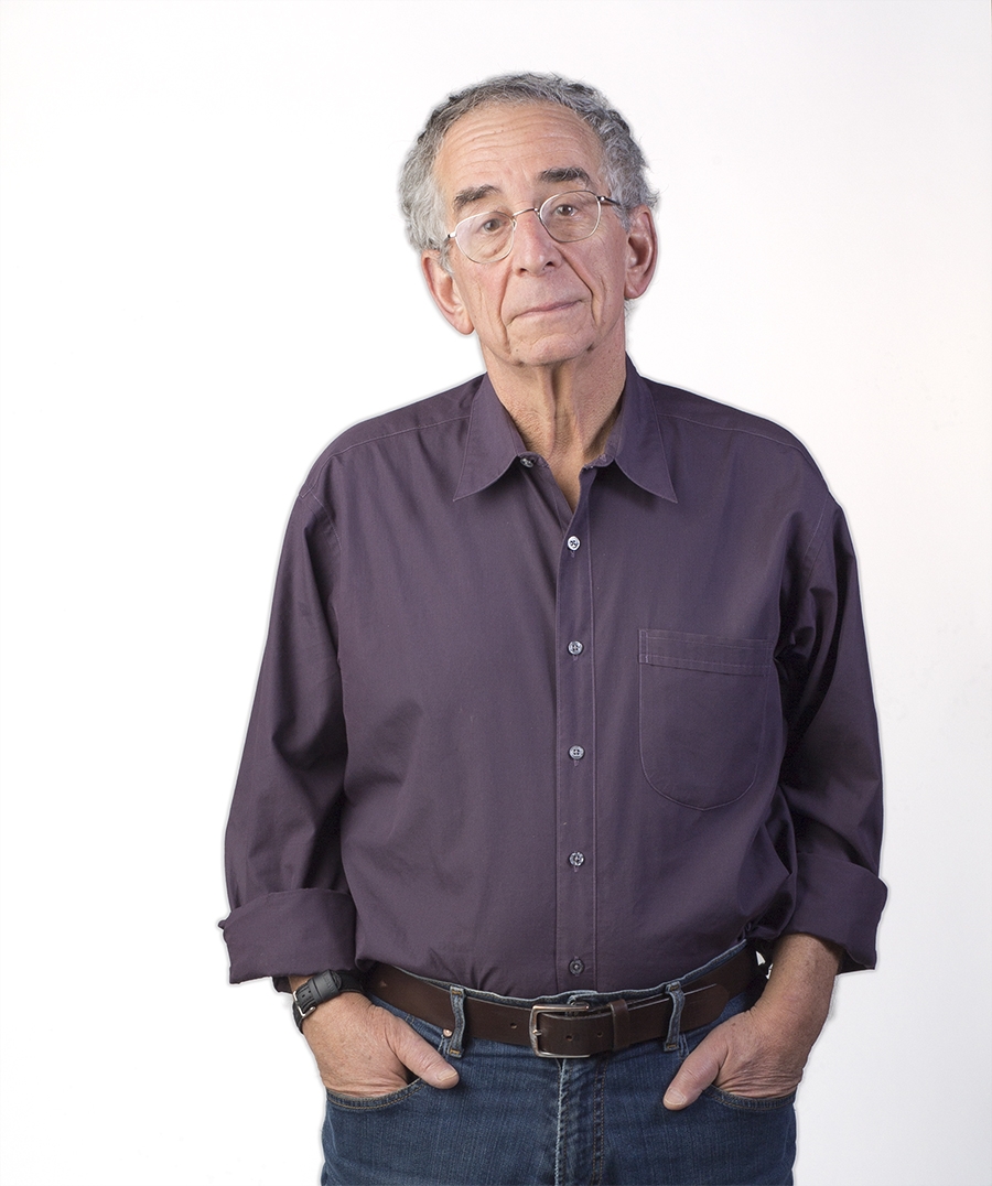Barry Schwartz, an older man, wears glasses and his hands are in his pockets.